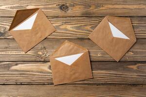 Stack of envelopes on working desk top view. Business mail photo