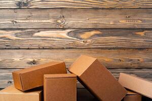 Pile of cardboard boxes on wooden background photo