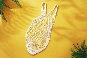 Empty string reusable bag on paper background, top view photo