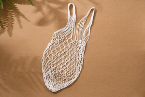 Empty string reusable bag on paper background, top view photo