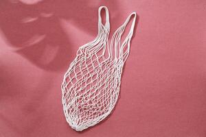 Empty string reusable bag on paper background, top view photo