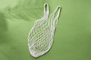 Empty string reusable bag on paper background, top view photo