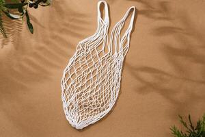 Empty string reusable bag on paper background, top view photo