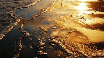 Golden sunlight reflecting on gentle ocean waves at dusk along the shoreline photo