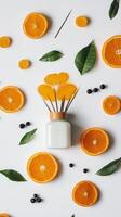 Colorful arrangement of orange slices and decorative reed diffuser on a white background for a vibrant and fresh decor photo