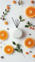 Decorative white diffuser surrounded by fresh orange slices and vibrant fruits on a light backdrop photo