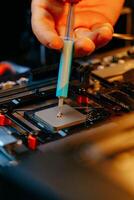 Applying thermal paste to a computer processor photo