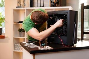 Man assembles a computer system unit at home photo