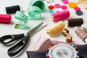 Crafting essentials for sewing projects displayed on a table with fabric, threads, and tools photo