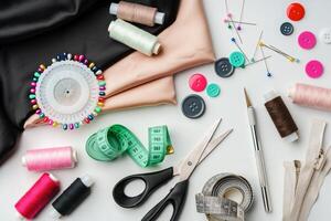Crafting essentials for sewing projects displayed on a table with fabric, threads, and tools photo