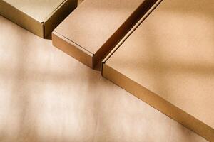 Brown cardboard boxes arranged on a neutral background in a warehouse setting during daylight hours photo