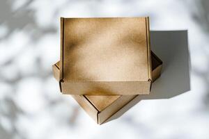 Freshly packed cardboard boxes resting on a white surface, illuminated by soft natural light photo