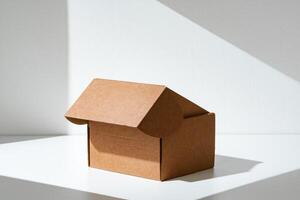 An open cardboard box rests on a bright white surface with soft shadows highlighting its edges and structure in natural light photo