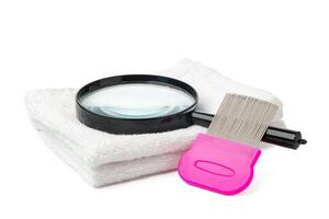 Anti lice combs and towel on white background photo