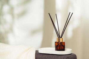 Aroma diffuser bottle with sticks in living room photo