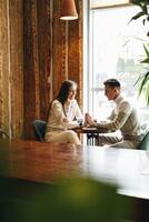 Casual Business Meeting Between Colleagues at a Cozy Cafe During Daytime photo
