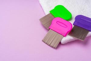 Three combs for removing lice and nits on lilac background photo
