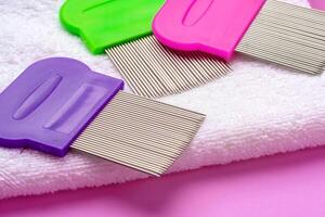 Three combs for removing lice and nits on lilac background photo