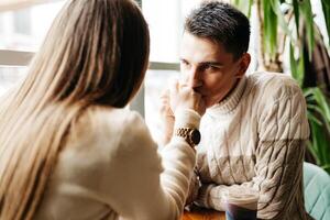 Young Couple Enjoying a Coffee Date at a Cozy Cafe During the Day photo