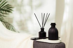 Aroma diffuser bottle with sticks in living room photo