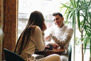Man and Woman Sitting at Table Talking photo
