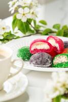 Multi-colored Japanese cakes Mochi in a white plate photo