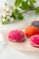 Multi-colored Japanese cakes Mochi in a white plate photo