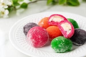 Multi-colored Japanese cakes Mochi in a white plate photo