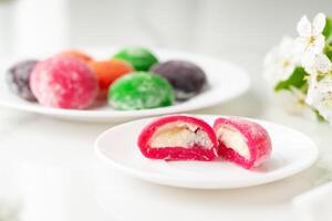 Multi-colored Japanese cakes Mochi in a white plate photo