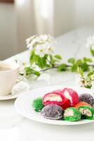 Multi-colored Japanese cakes Mochi in a white plate photo