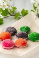 Multi-colored Japanese cakes Mochi in a white plate photo