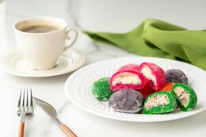 Multi-colored Japanese cakes Mochi in a white plate photo