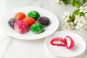Multi-colored Japanese cakes Mochi in a white plate photo