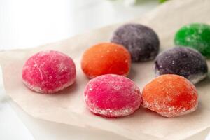 Multi-colored Japanese cakes Mochi in a white plate photo