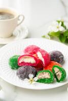 Multi-colored Japanese cakes Mochi in a white plate photo