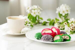 Multi-colored Japanese cakes Mochi in a white plate photo