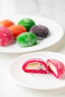 Multi-colored Japanese cakes Mochi in a white plate photo