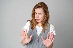 Woman in Vest Holding Hands Up in Studio photo