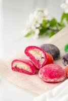 Multi-colored Japanese cakes Mochi in a white plate photo