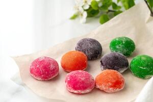 Multi-colored Japanese cakes Mochi in a white plate photo