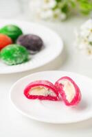 Multi-colored Japanese cakes Mochi in a white plate photo