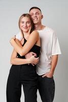 A Man and a Woman Standing Next to Each Other in studio photo