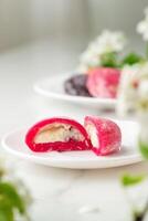 Multi-colored Japanese cakes Mochi in a white plate photo