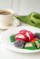 Multi-colored Japanese cakes Mochi in a white plate photo