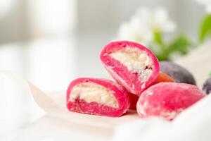 Multi-colored Japanese cakes Mochi in a white plate photo