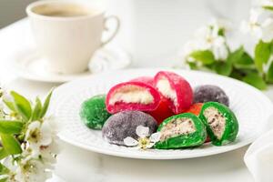 Multi-colored Japanese cakes Mochi in a white plate photo