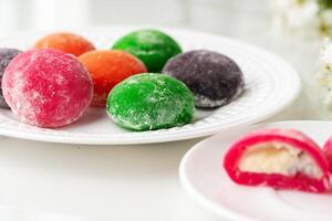 Multi-colored Japanese cakes Mochi in a white plate photo