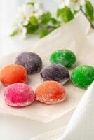 Multi-colored Japanese cakes Mochi in a white plate photo
