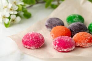 Multi-colored Japanese cakes Mochi in a white plate photo