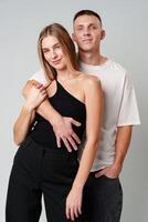 A Man and a Woman Standing Next to Each Other in studio photo